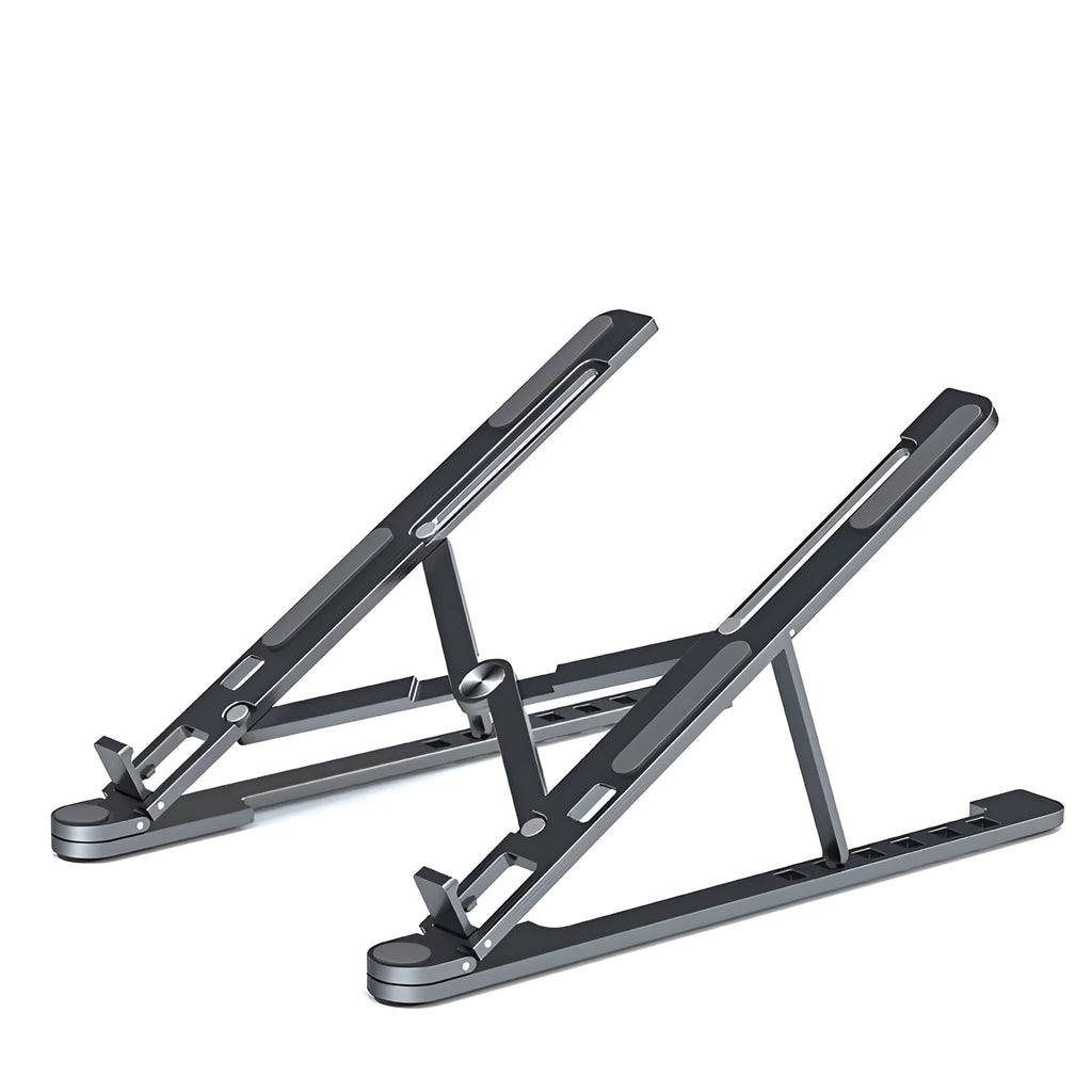 A folded deep grey aluminium laptop stand next to an open silver laptop on a desk.