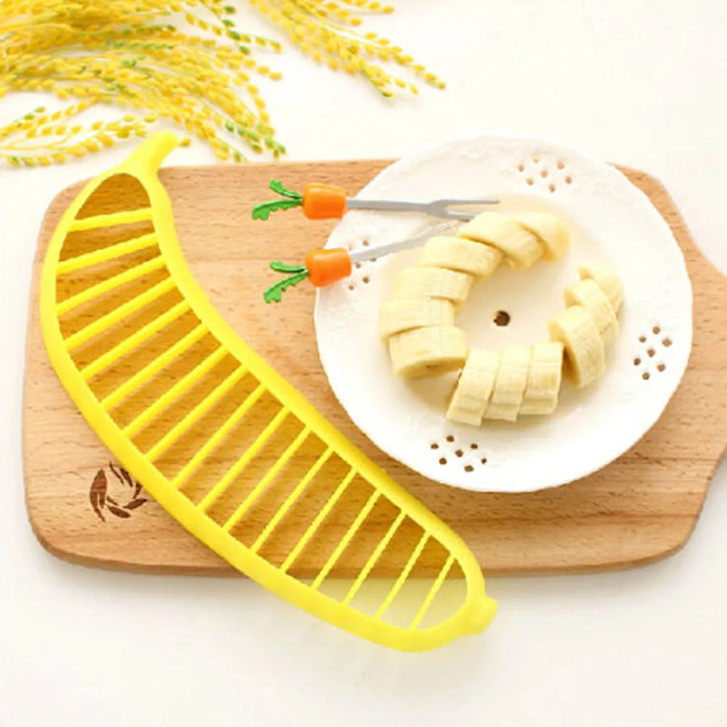 Yellow banana cutter food grade PP plastic kitchen tool approximately 25 cm long on a white background