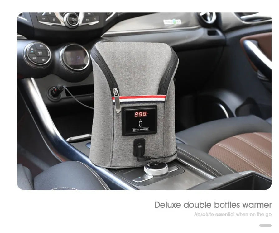 Grey Oxford cloth portable baby bottle warmer with carry handle and electronic display for car travel.