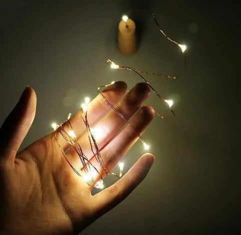 Flexible copper wire LED string light with bottle stopper for wine bottle decoration.