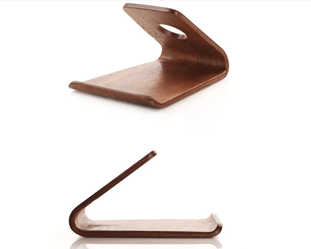 A wooden phone stand holding an iPhone in landscape mode on a desk.