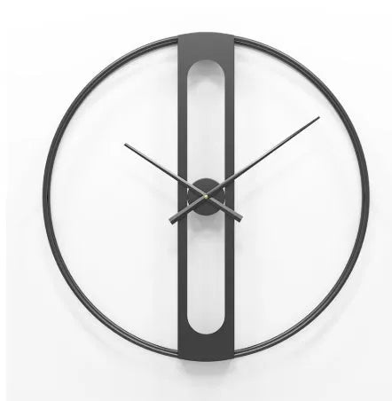 Large round metal wall clock with black dial and gold Arabic numerals on a white wall