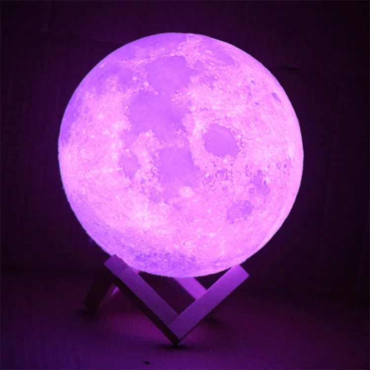 3D printed white moon lamp with detailed craters on a wooden stand, showing touch ring at base