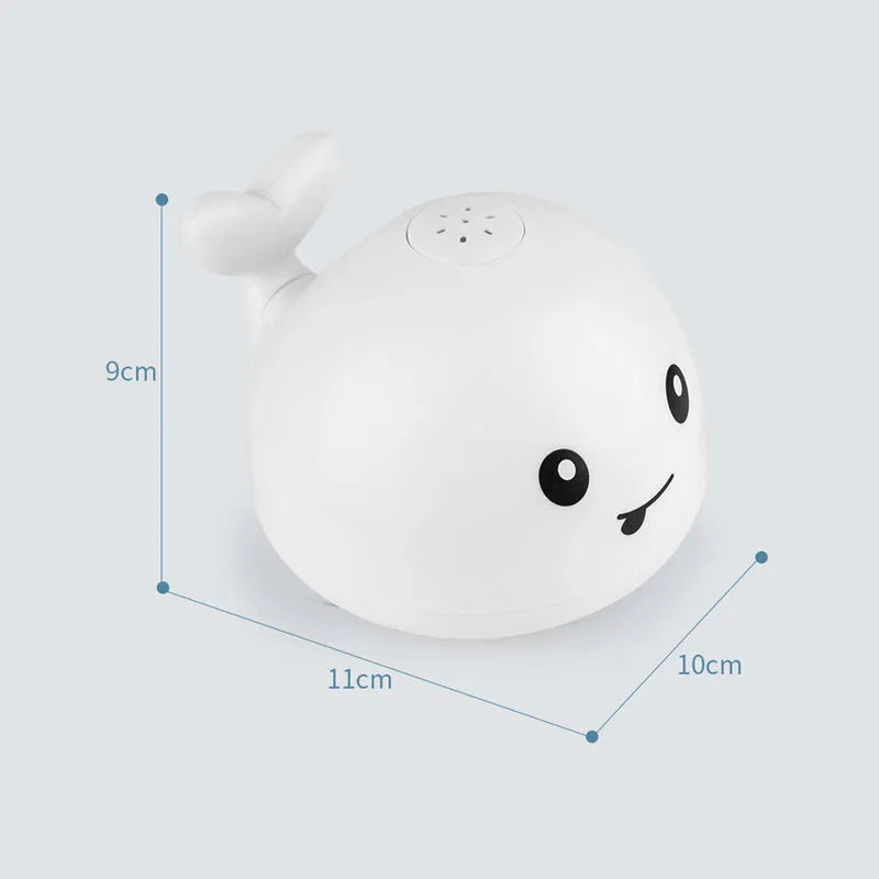 White and blue whale bath toy spraying water with LED lights illuminated