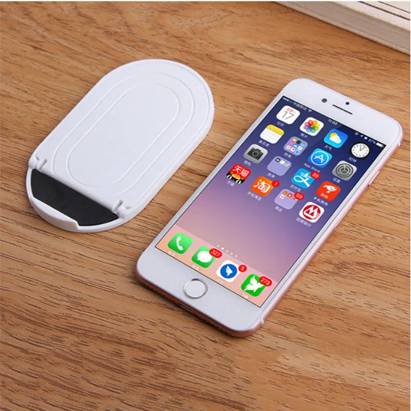 Plastic mobile phone stand in six colour options showing bracket design for desk use