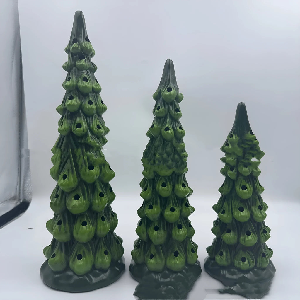 A resin Christmas tree-shaped lamp ornament with LED lights, shown in different sizes on a table.