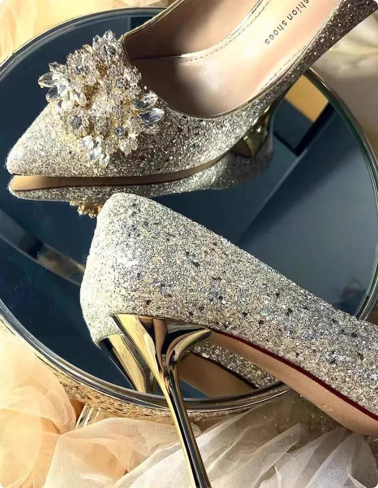 Champagne-coloured women's bridal shoes with rhinestone details, pointed toe, and a fine heel.