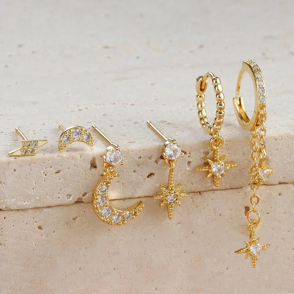 Set of six gold-colour chain tassel earrings with zircon studs, shown arranged together.