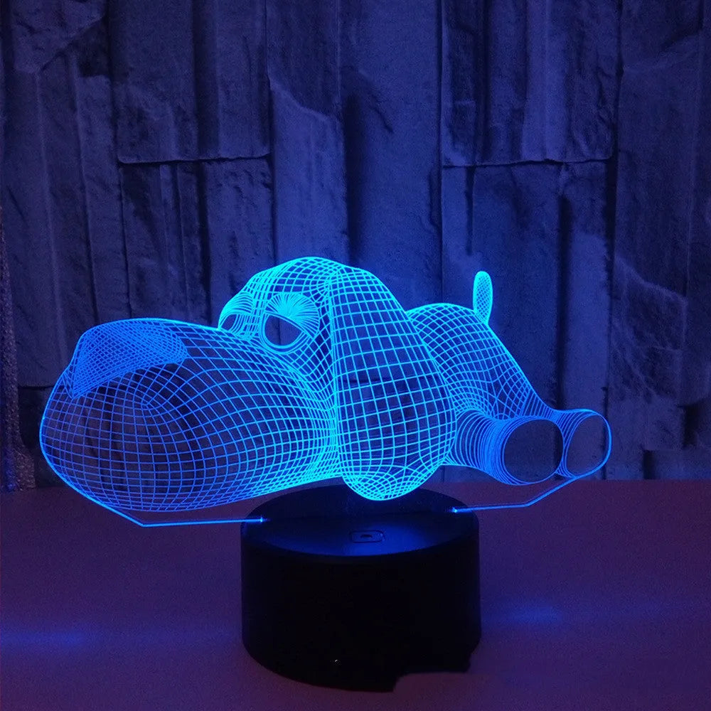 Doggo desktop lamp with 3D illusion design glowing in multiple colours on a desk.