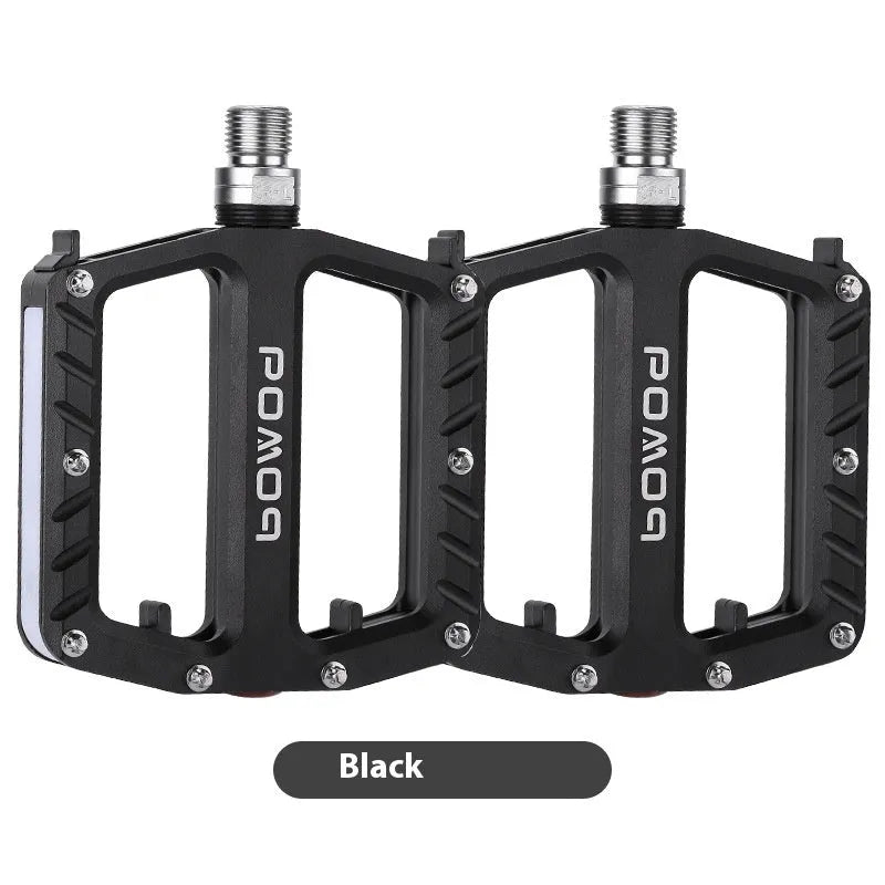 Pair of aluminium alloy bicycle pedals with integrated LED lights in multiple colour options.