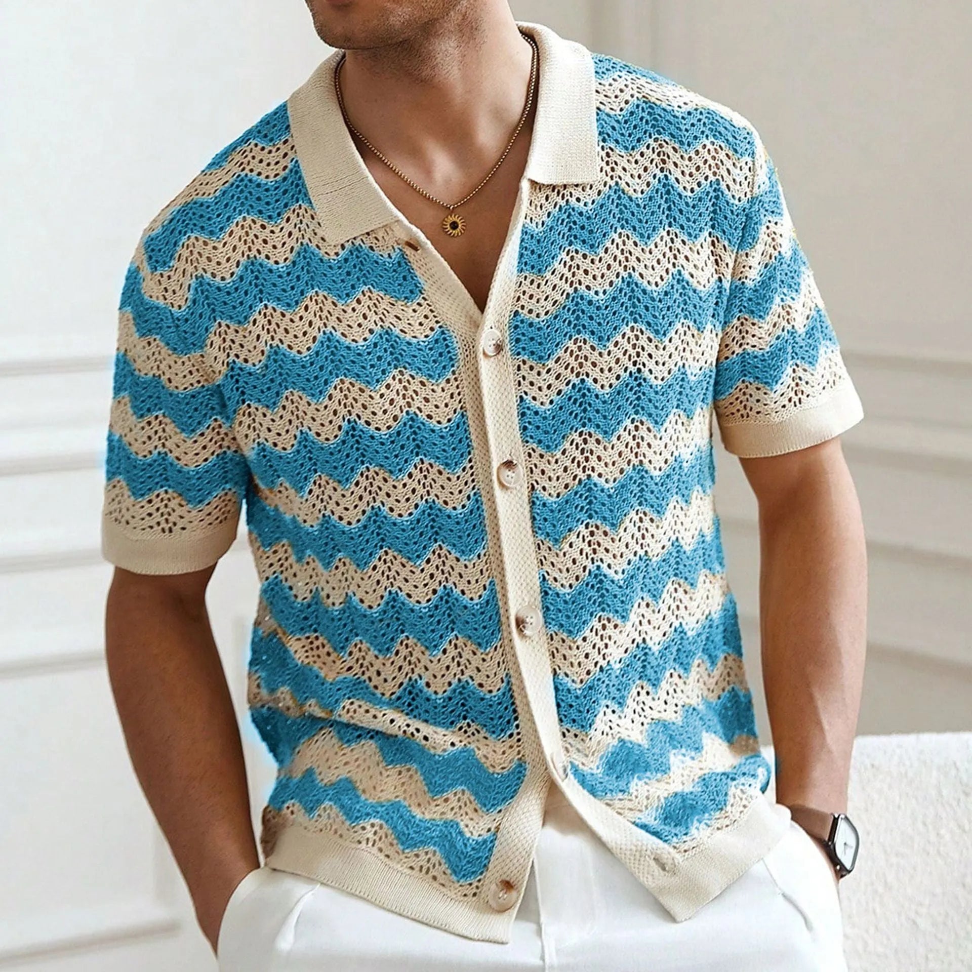 Short-sleeved yellow corrugated knit sweater with flocking detail on a hanger.
