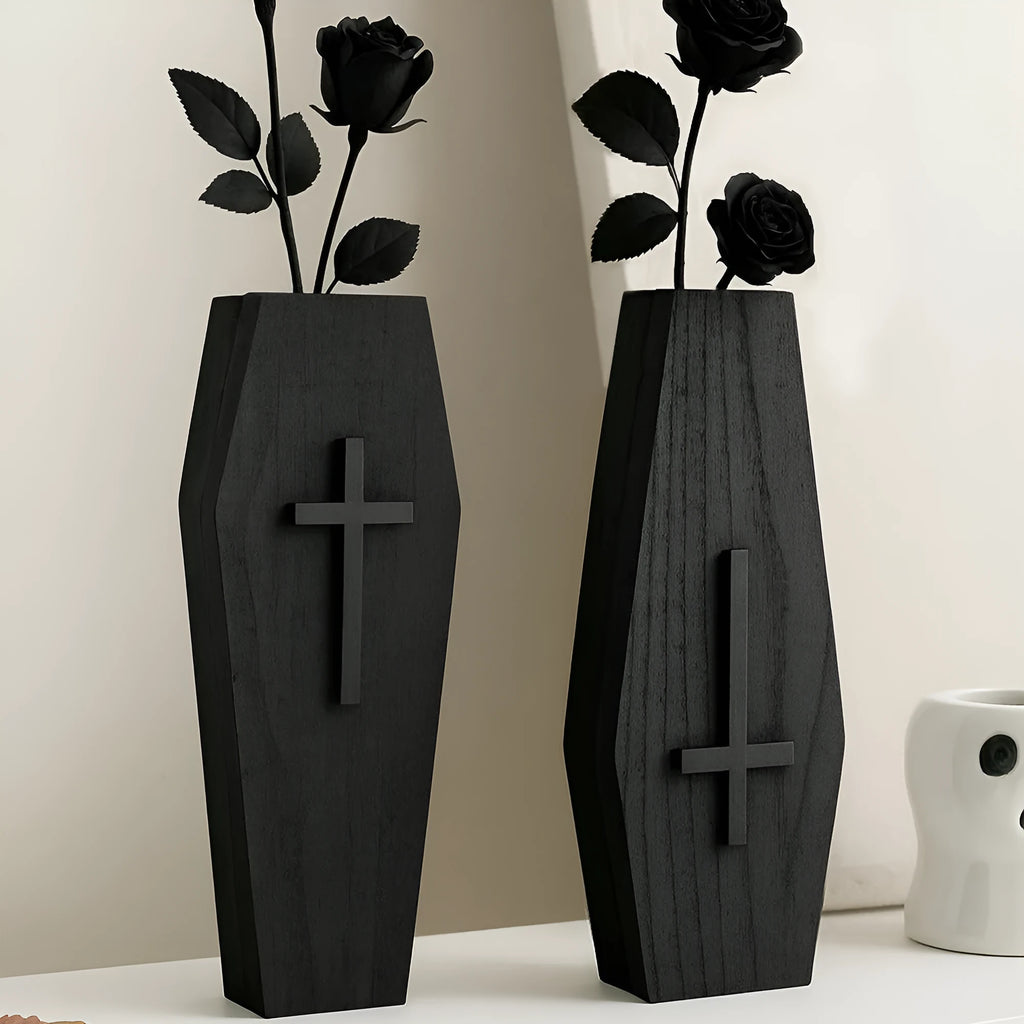 Black wooden cross-shaped wall shelf with space for holding small plants or decorative items.