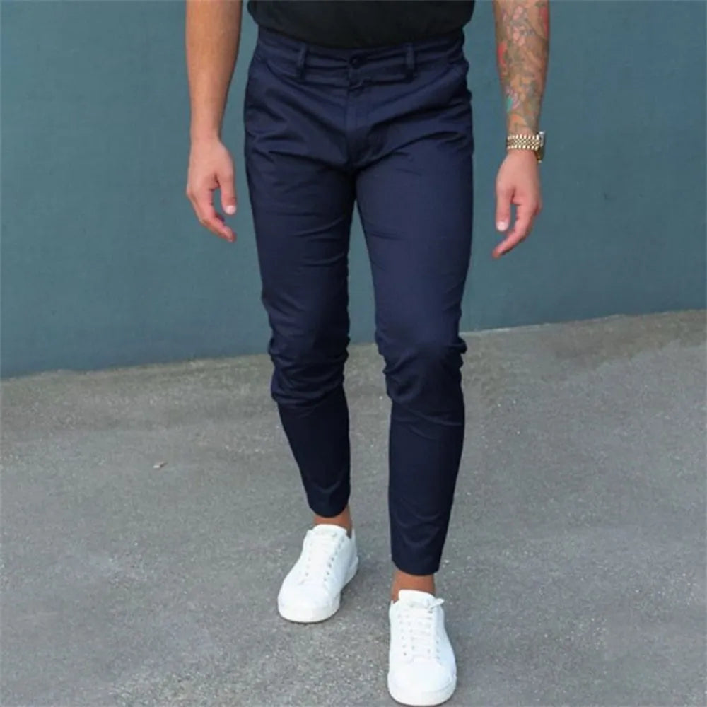 Men's pure color tight trousers in black, side view, showing mid waist and micro-elastic polyester fabric.
