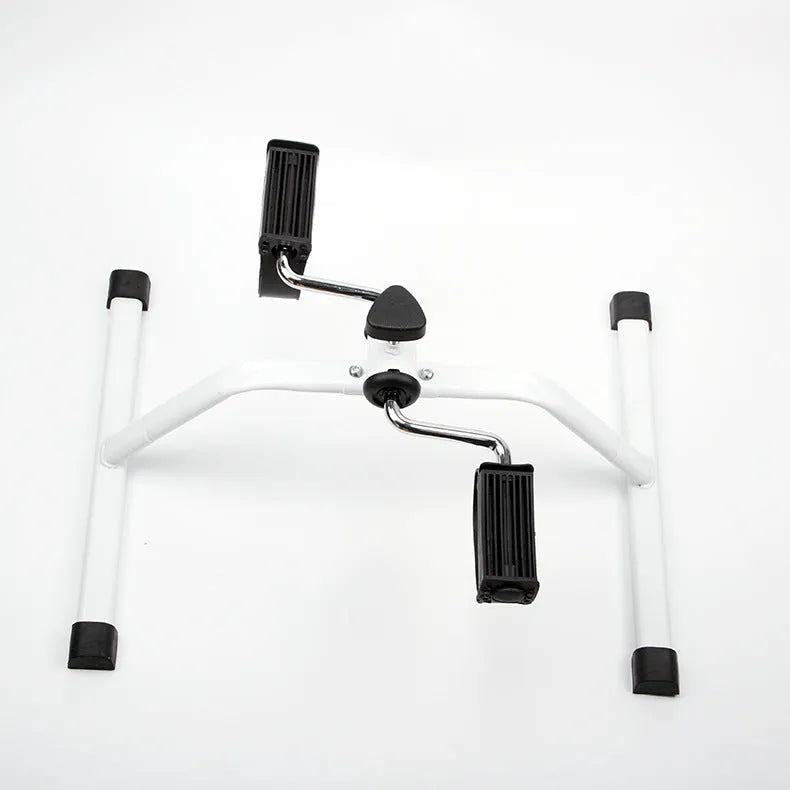 White mini exercise bike with non-slip pedals and monitor on rubber feet