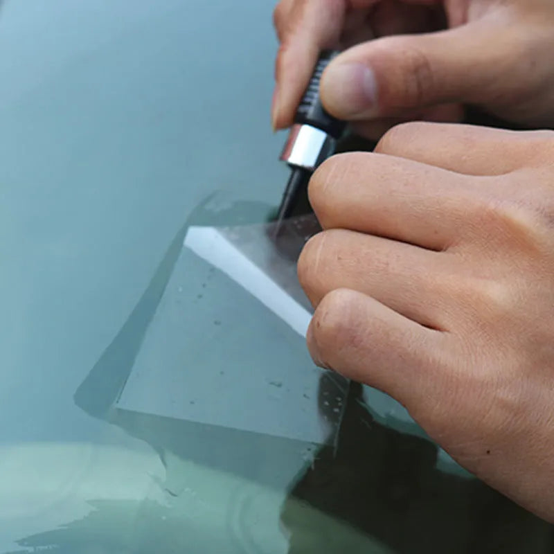 Yellow three-piece car windscreen repair kit with glass repair liquid and application tools