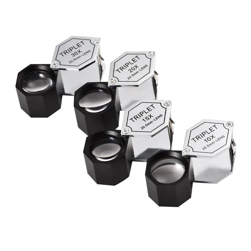Handheld metal magnifying glass with optical glass lens for jewellery and coin identification.