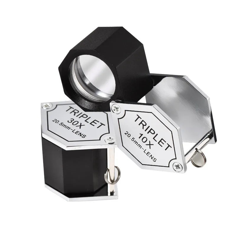 Handheld metal magnifying glass with optical glass lens for jewellery and coin identification.