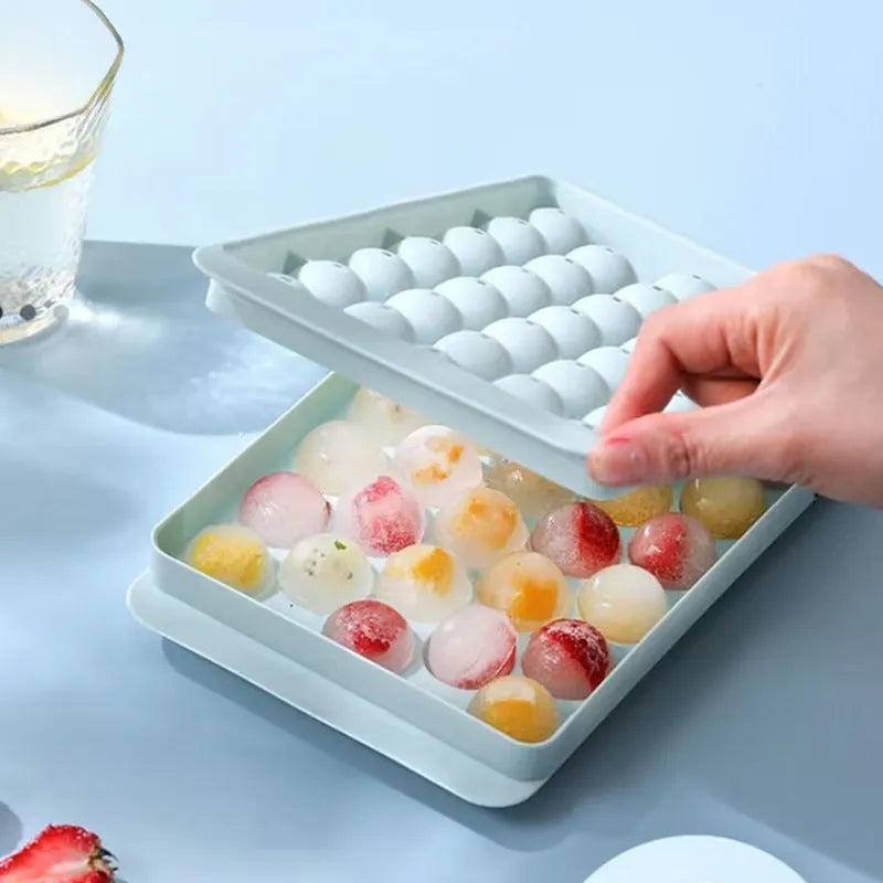 Blue silicone ice cube tray with lid showing 33 round compartments