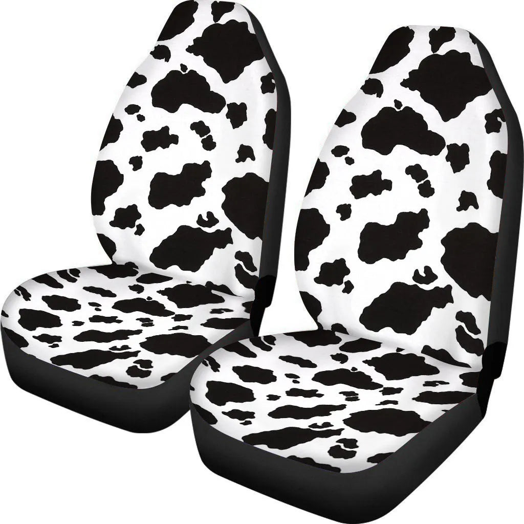 Pair of universal car seat covers in a cow spot leopard print retro pattern on a car front seat.