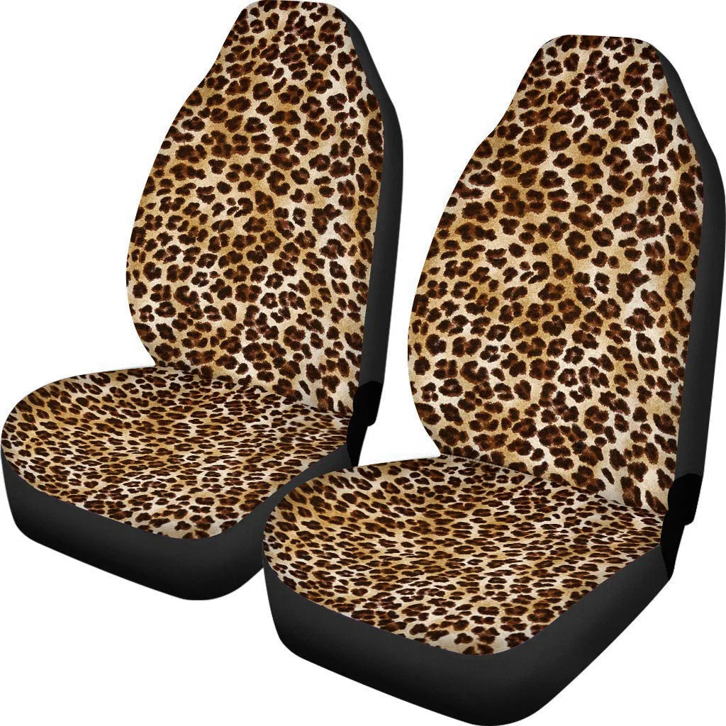 Pair of universal car seat covers in a cow spot leopard print retro pattern on a car front seat.