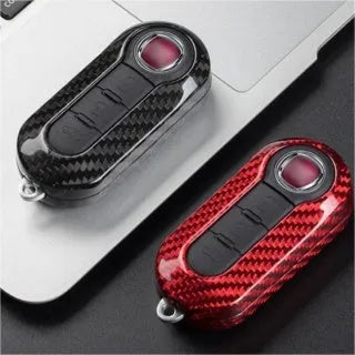 Carbon fibre vehicle key shell replacement cover showing precise button cutouts and textured surface