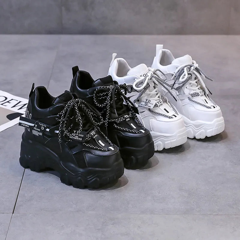 White women's low-top platform trainers with breathable mesh and a black cross-strap.