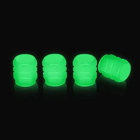 Luminous rubber tyre valve caps in light green, blue, red, yellow, and pink colours on a wheel valve.