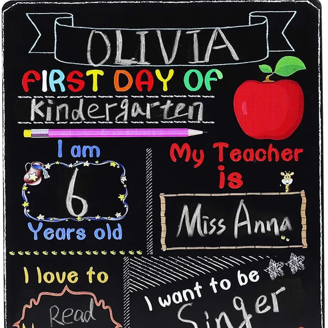 Wooden first day of school blackboard sign on a simple background.