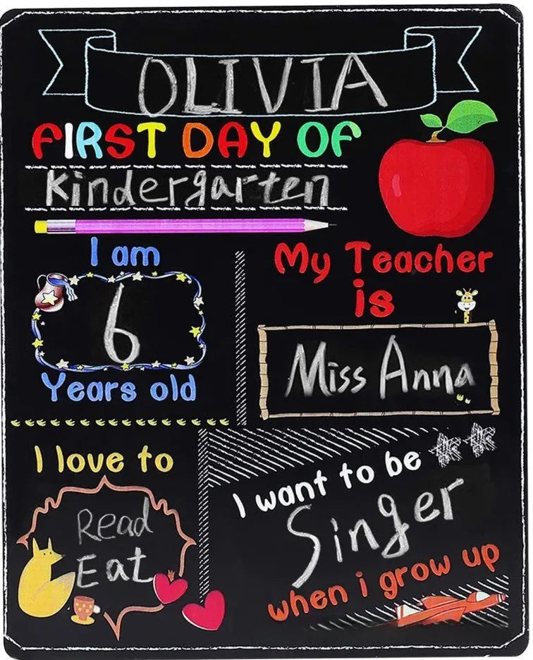 Wooden first day of school blackboard sign on a simple background.
