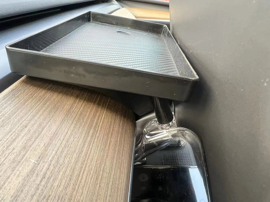 Black ABS storage box for Tesla Model 3 and Y, positioned under the centre touchscreen.