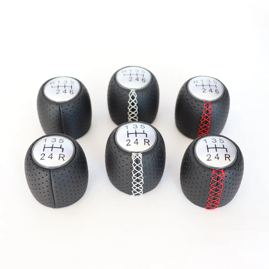 Sewn wrapped perforated leather gear lever handball for Alpha car in black, red, and white line options.