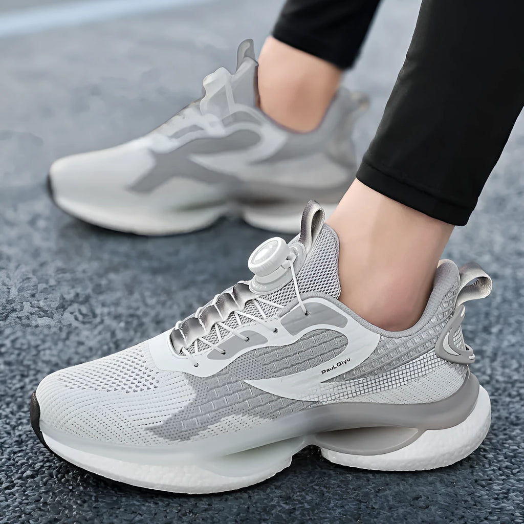 Men's white low-top running shoes with a rotating buckle closure and fly-knit mesh upper.
