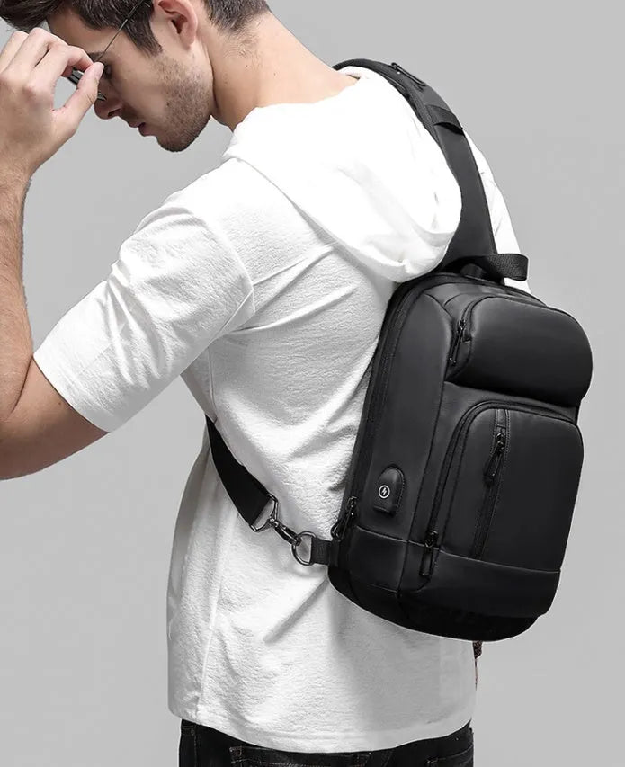 Black medium-sized PVC outdoor shoulder bag showing front view and interior laptop compartment.