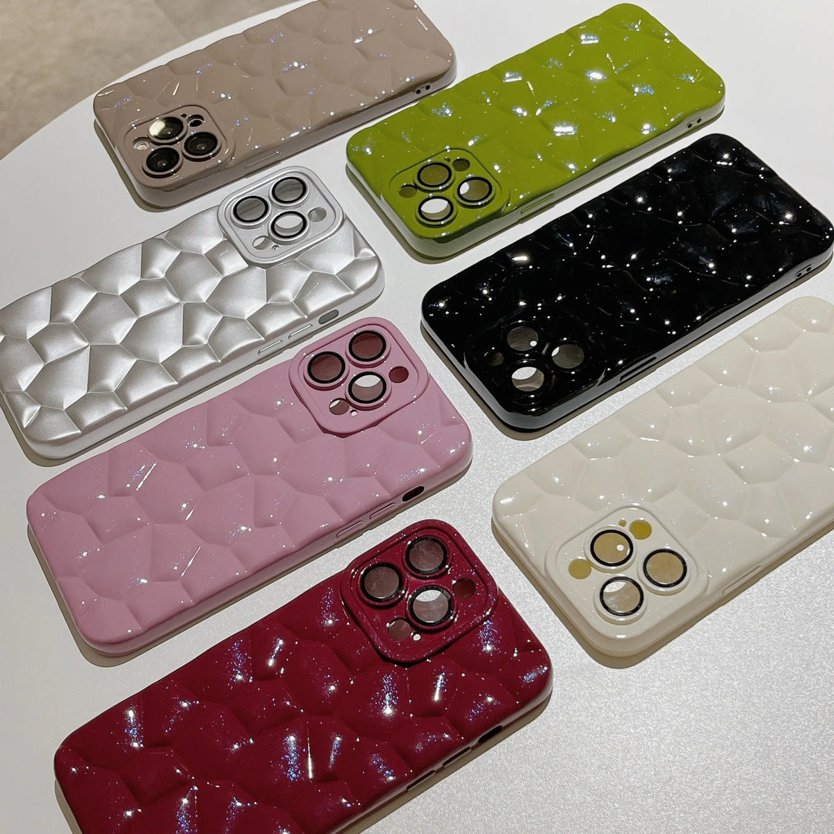 Pebble TPU mobile phone shell with lens protector for iPhone 11 to 15 Pro Max, shown in black, silver, white, brown, green, pink, and red