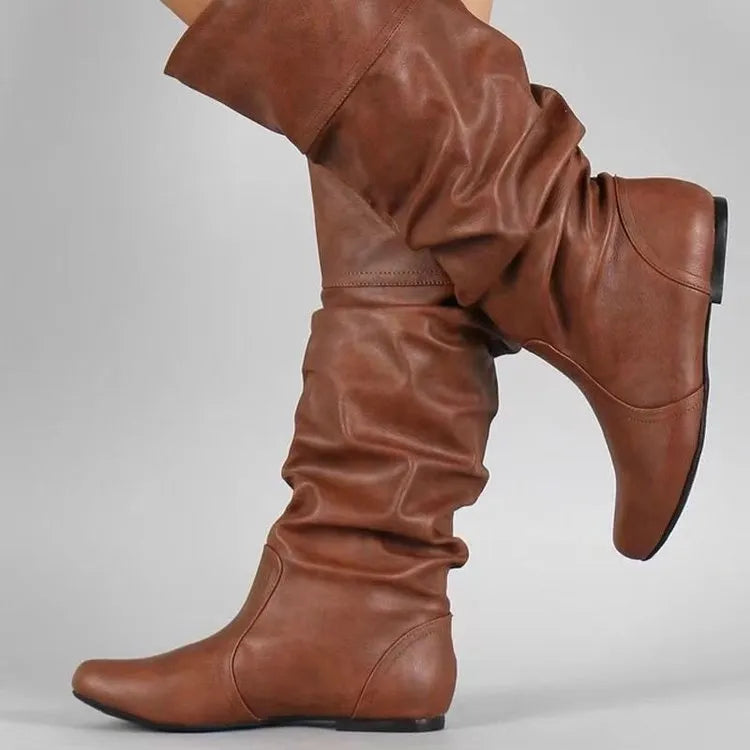 Women's flat-heel slip-on long boots in black with a round toe and high shaft.