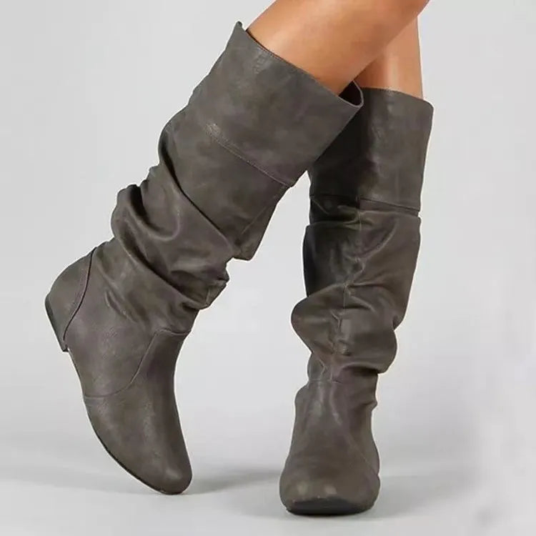 Women's flat-heel slip-on long boots in black with a round toe and high shaft.