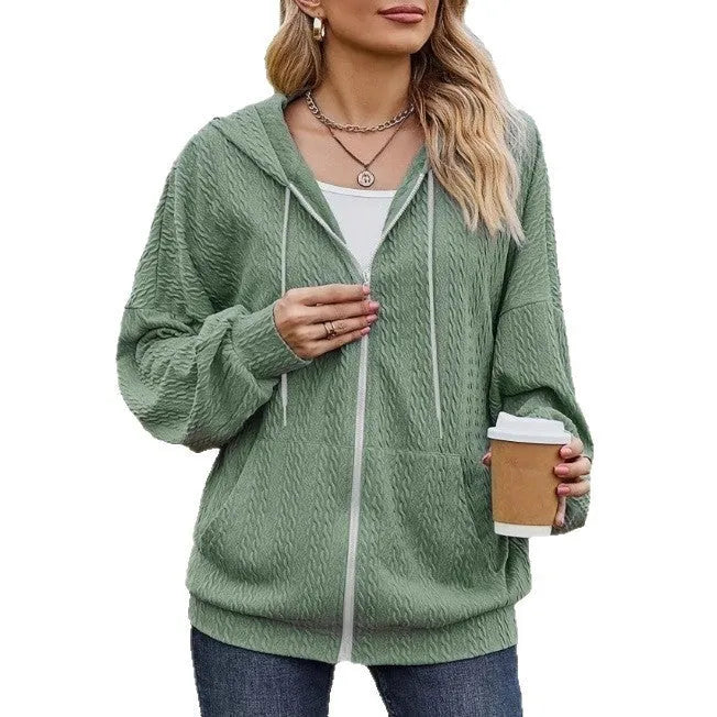 Green women's loose fit hooded sweater coat with a front zip closure on a hanger.