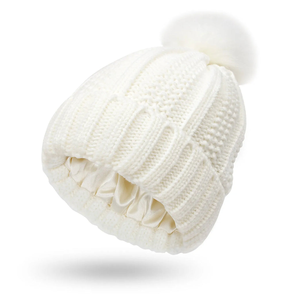 Women's satin-lined wool beanie with faux fur pom pom in various colours