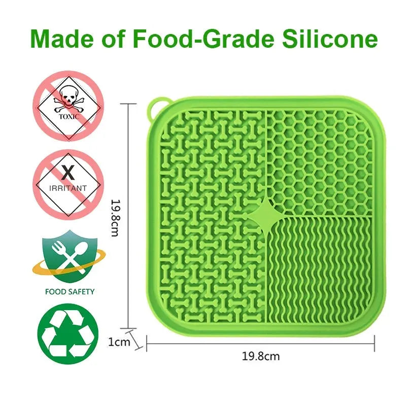 Orange red silicone dog lick mat with suction cups on a smooth surface.