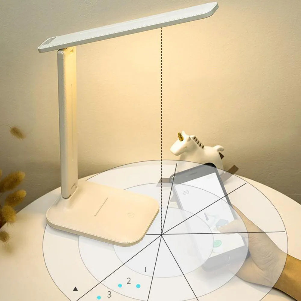 White plastic USB rechargeable bedside lamp with touch dimming control on a wooden surface.