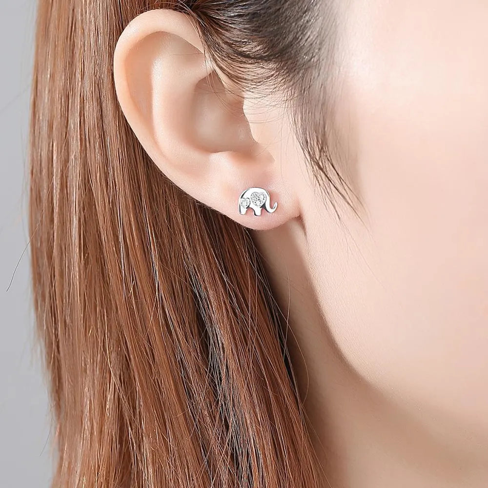 Geometric silver stud earrings with gem setting, shown in gold and silvery colour options.