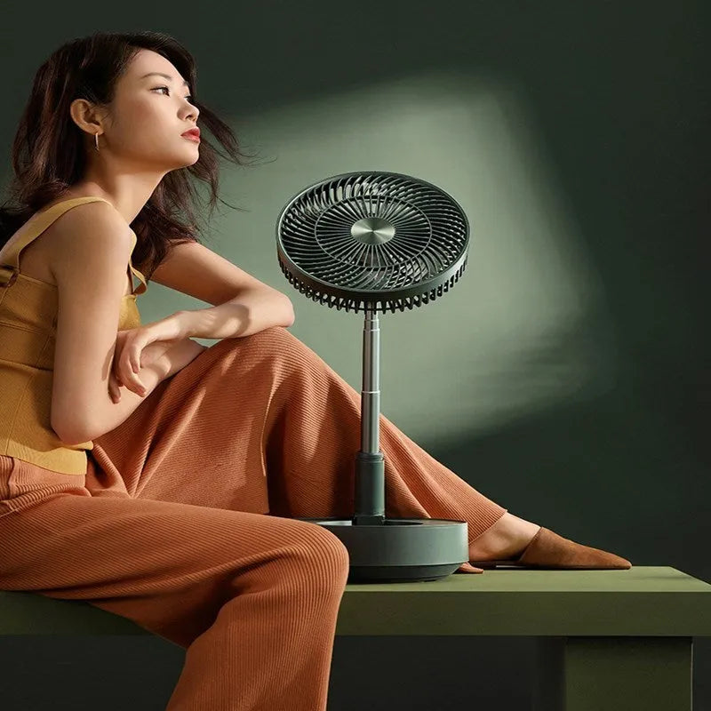 Green and white telescopic rechargeable floor fan with remote control, shown in both desktop and extended height modes.