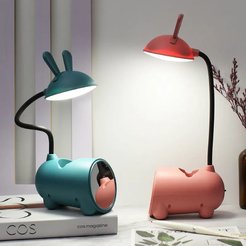 Cartoon-themed USB desk lamp with built-in pen container in green, dark blue, or pink colour options
