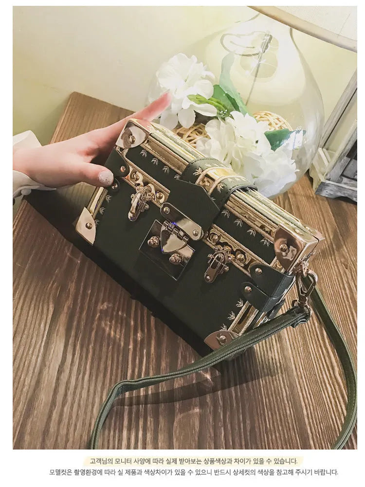 Hard structured black PU leather women's shoulder bag with decorative rivets and single adjustable strap