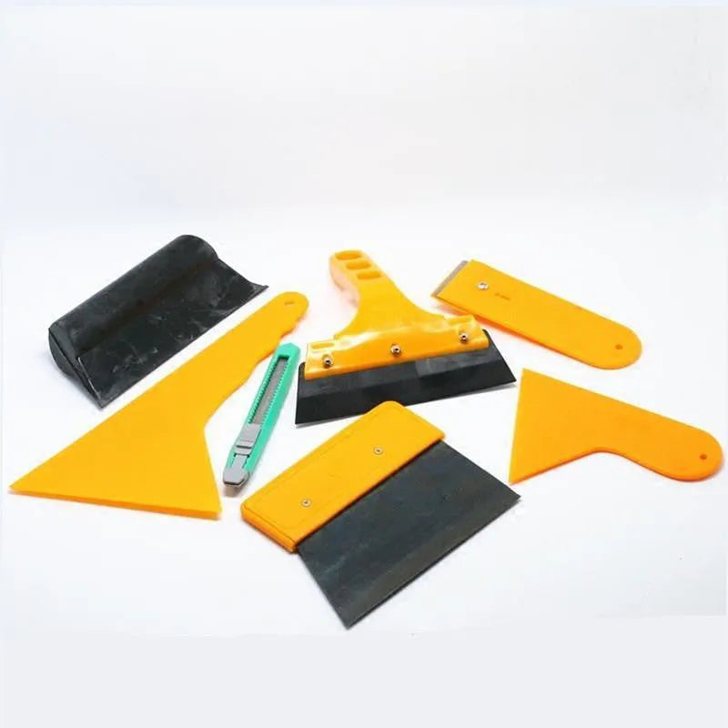 Seven-piece automotive and architectural film tool set with scrapers, knives, and a pressing block.