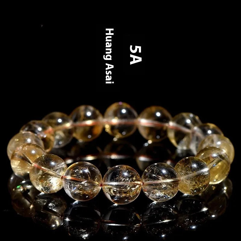 Natural yellow citrine gemstone bracelet with geometric beads on a white background.