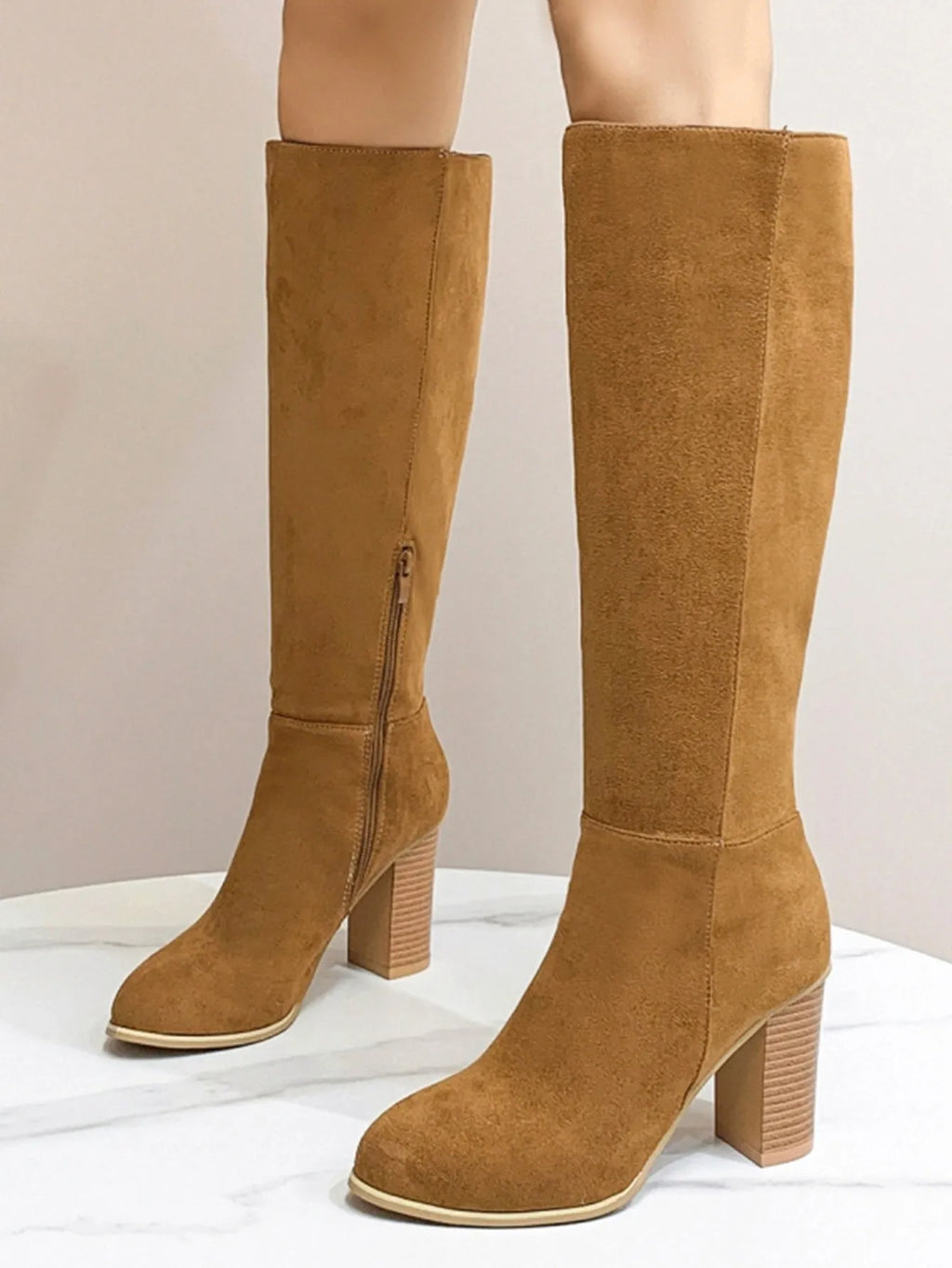 Women's black square toe high heel fashion boot made of artificial PU material.