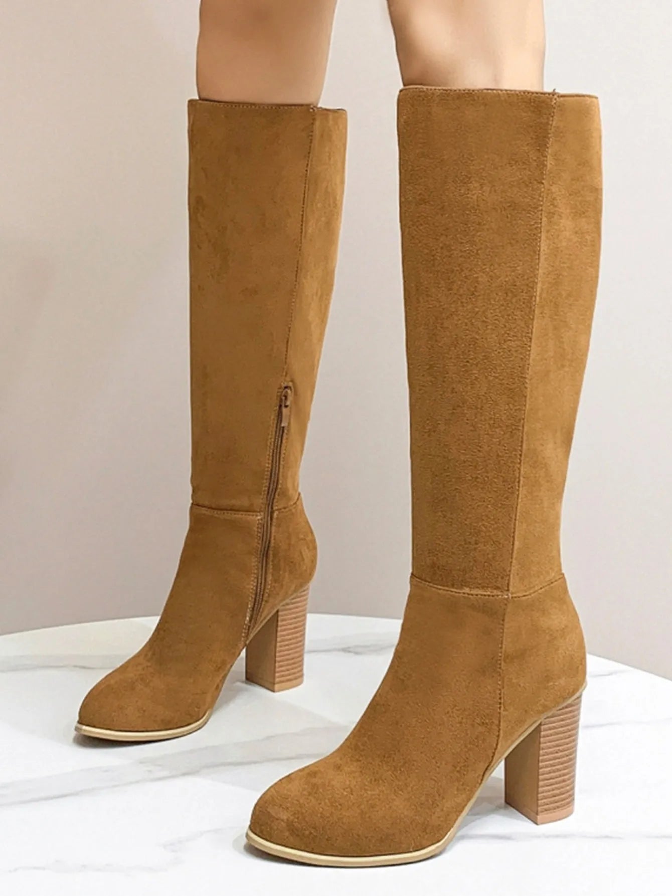 Women's black square toe high heel fashion boot made of artificial PU material.