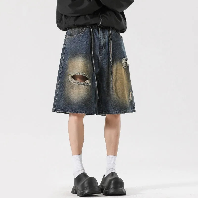 Retro blue loose fit ripped jeans with distressed detailing on denim fabric