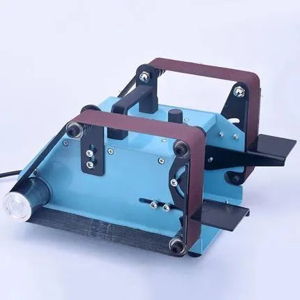 Blue desktop dual-axis belt sander on a workbench for knife sharpening and polishing